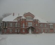 The north face of the manor house during winter.